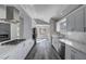 Open kitchen layout featuring white cabinetry, modern appliances, and gray flooring at 5236 Woodlawn Ln, Las Vegas, NV 89130