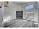 Bright living room features high ceilings, gray flooring, modern fireplace, and abundant natural light at 5236 Woodlawn Ln, Las Vegas, NV 89130