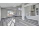 Bright living room with grey flooring, high ceilings, and large windows at 5236 Woodlawn Ln, Las Vegas, NV 89130