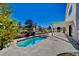 Refreshing backyard pool and spa with a covered patio, surrounded by mature landscaping at 5236 Woodlawn Ln, Las Vegas, NV 89130