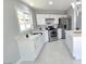 Updated kitchen featuring white cabinets and an island at 5260 San Anselmo St, Las Vegas, NV 89120