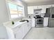 Modern kitchen with white cabinets and stainless steel appliances at 5260 San Anselmo St, Las Vegas, NV 89120