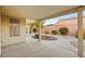 This covered back patio features a concrete floor and a landscaped backyard at 5804 Sassa St, Las Vegas, NV 89130