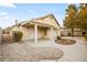 Private backyard featuring a covered patio and low maintenance desert landscaping at 5804 Sassa St, Las Vegas, NV 89130