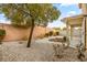 This low-maintenance backyard features desert landscaping and a covered patio at 5804 Sassa St, Las Vegas, NV 89130