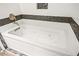 A luxurious, tiled bathtub provides an exquisite bathing experience at 5804 Sassa St, Las Vegas, NV 89130