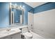 A well-lit bathroom with a sink, toilet, and shower at 5804 Sassa St, Las Vegas, NV 89130