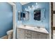 Bathroom with a double sink vanity and framed mirrors and a separate toilet area at 5804 Sassa St, Las Vegas, NV 89130