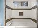 Bathroom with a tub featuring tiled walls and a shower at 5804 Sassa St, Las Vegas, NV 89130