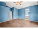 Bedroom showcasing blue walls, wood-look tile floors, and ensuite bathroom with a white vanity at 5804 Sassa St, Las Vegas, NV 89130