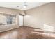 Well-lit empty bedroom featuring wood-look floors, ceiling fan, and a sunny window at 5804 Sassa St, Las Vegas, NV 89130