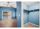 Blue bedroom featuring wood-look tile floors, sliding glass doors to backyard, and a closet at 5804 Sassa St, Las Vegas, NV 89130