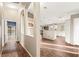 Hallway leading to the kitchen, with views of the living room and backyard through arched openings at 5804 Sassa St, Las Vegas, NV 89130