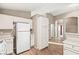 Bright kitchen featuring white appliances, plenty of cabinets and wood-look floors at 5804 Sassa St, Las Vegas, NV 89130