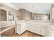 Bright kitchen with white cabinets and breakfast bar overlooking the living area at 5804 Sassa St, Las Vegas, NV 89130