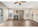 Cozy living room with a fireplace, windows and sliding glass door with wood-look floors at 5804 Sassa St, Las Vegas, NV 89130