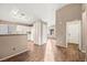 Bright open-plan living area with wood-look flooring connecting the kitchen at 5804 Sassa St, Las Vegas, NV 89130