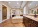 Spa-like bathroom with soaking tub, walk-in shower, and double vanity at 59 Portezza Dr, Henderson, NV 89011