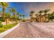 Gated community entrance with palm trees and stone architecture at 59 Portezza Dr, Henderson, NV 89011