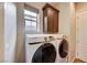 Laundry room with Samsung washer and dryer, cabinets and a utility sink at 59 Portezza Dr, Henderson, NV 89011