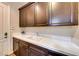 Laundry room with cabinets and utility sink at 59 Portezza Dr, Henderson, NV 89011