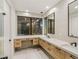 Bright bathroom featuring double sinks, modern cabinetry, and a large picture window with views at 591 Overlook Rim Dr, Henderson, NV 89012