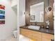 Contemporary bathroom featuring a stylish vanity with vessel sink, unique lighting, and modern finishes at 591 Overlook Rim Dr, Henderson, NV 89012