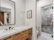 Bright bathroom with a large mirror, modern vanity, and a glass-enclosed shower, showcasing contemporary design at 591 Overlook Rim Dr, Henderson, NV 89012