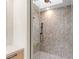 Modern shower featuring decorative tile and contemporary fixtures under a skylight at 591 Overlook Rim Dr, Henderson, NV 89012