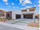 Modern home with two-car garage and landscaped front yard at 591 Overlook Rim Dr, Henderson, NV 89012