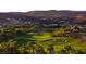 Lush green golf course set against a backdrop of desert mountains and hillside homes at 591 Overlook Rim Dr, Henderson, NV 89012