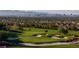 Scenic golf course view with lush green grass, sand traps, and the Las Vegas skyline in the background at 591 Overlook Rim Dr, Henderson, NV 89012