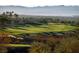 Scenic view of a lush golf course with rolling hills and mature trees in the distance at 591 Overlook Rim Dr, Henderson, NV 89012