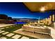 Luxurious outdoor area featuring a pool, dining area, and stunning city views at night at 591 Overlook Rim Dr, Henderson, NV 89012