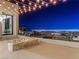 Relaxing rooftop deck with a modern fire pit and breathtaking panoramic city views at night at 591 Overlook Rim Dr, Henderson, NV 89012