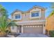 Two-story house with a beige exterior, two-car garage, and palm trees at 5993 Lambert Bridge Ave, Las Vegas, NV 89139