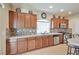 Well-equipped kitchen featuring wood cabinets and granite countertops at 5993 Lambert Bridge Ave, Las Vegas, NV 89139