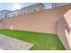 Artificial turf in a backyard with brick privacy wall and pavers at 7075 Jasper Hill Way, Las Vegas, NV 89118