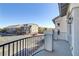 Balcony view showcasing neighborhood architecture with wrought iron railing and classic column design at 7075 Jasper Hill Way, Las Vegas, NV 89118