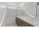 Modern bathroom featuring dual vanity, large mirror, and a combined shower and tub at 7075 Jasper Hill Way, Las Vegas, NV 89118