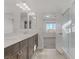 Bathroom with double vanity, large mirror and view into bedroom at 7075 Jasper Hill Way, Las Vegas, NV 89118