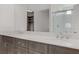 Double vanity bathroom with modern gray cabinets and quartz countertops at 7075 Jasper Hill Way, Las Vegas, NV 89118