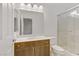 Bathroom features updated vanity, large mirror, modern lighting, and glass shower at 7075 Jasper Hill Way, Las Vegas, NV 89118