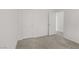 The carpeted bedroom features neutral decor and easy access to another room at 7075 Jasper Hill Way, Las Vegas, NV 89118
