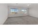 Sun-filled bedroom with carpet and large windows offering neighborhood views at 7075 Jasper Hill Way, Las Vegas, NV 89118