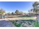Community dog park with green space, trees, and seating in a well-maintained neighborhood at 7075 Jasper Hill Way, Las Vegas, NV 89118