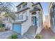 Two-story home with gray siding, blue door, and a stone stairway at 7075 Jasper Hill Way, Las Vegas, NV 89118