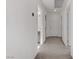 Clean, neutral-toned hallway with carpeted flooring, leading to various rooms within the home at 7075 Jasper Hill Way, Las Vegas, NV 89118