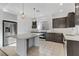 Modern kitchen features stainless steel appliances, quartz countertop, and island seating at 7075 Jasper Hill Way, Las Vegas, NV 89118
