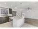 Open kitchen features an island and flows into the living room at 7075 Jasper Hill Way, Las Vegas, NV 89118